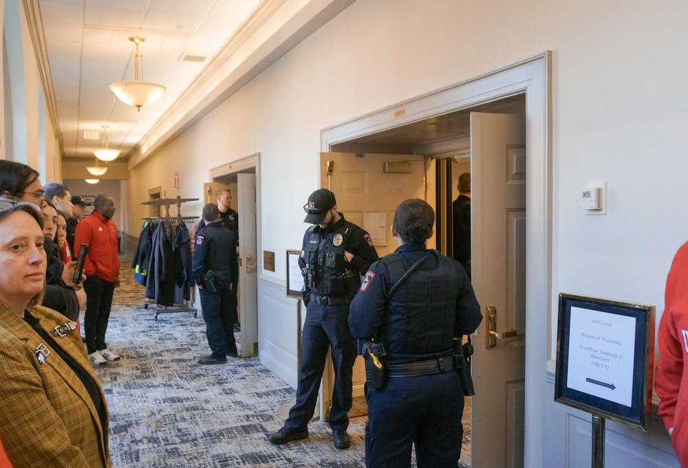 Campus police stand in front of the doors to the Miami Board of Trustees meeting. Photo by Abe Hagood | The Miami Student 